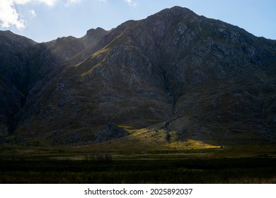 Photo Of The Sun Light Breaking Through Clouds On A Mountain