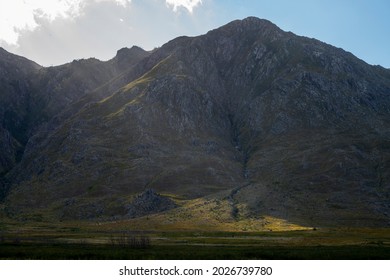 Photo Of The Sun Light Breaking Through Clouds On A Mountain