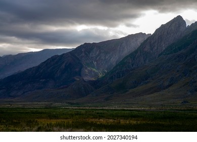 Photo Of The Sun Light Breaking Through Clouds On A Mountain