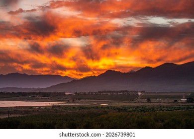 photo of the sun setting in a fiery red sky - Powered by Shutterstock