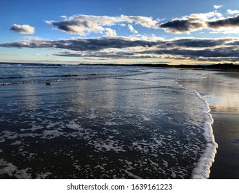 A photo of a sunset at Ogunquit Beach in Maine 2020 with a lone seagull in the waves