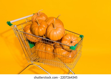 Photo Of Supermarket Trolley Shop Cart Pile Stack Pumpkin Vegetable Isolated On Yellow Color Background