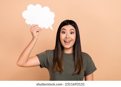 Photo of surprise funky girl japanese wear khaki t-shirt hold paper bubble cloud information idea eureka isolated on beige color background - Shutterstock ID 2311693131