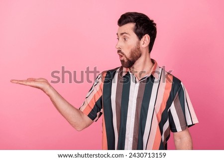 Photo of surprised funny mature age businessman hold new product object his hand cheapest on market isolated over pink color background