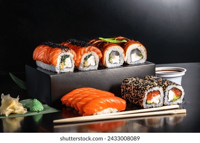 Photo of sushi menu, rolls, Japanese cuisine isolated on a black background with elements of hands, Chinese chopsticks
 - Powered by Shutterstock