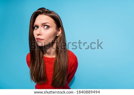 Photo of suspicious lady look distrustful on camera wear red knitted sweater isolated blue color background