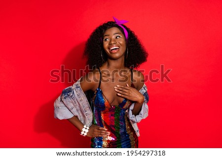 Photo of sweet charming curly dark skin woman dressed pinup clothes arm waist looking empty space isolated red color background