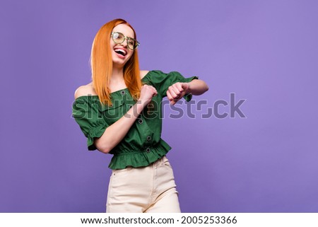 Photo of sweet charming young woman dressed off-shoulders blouse spectacles dancing smiling isolated violet color background