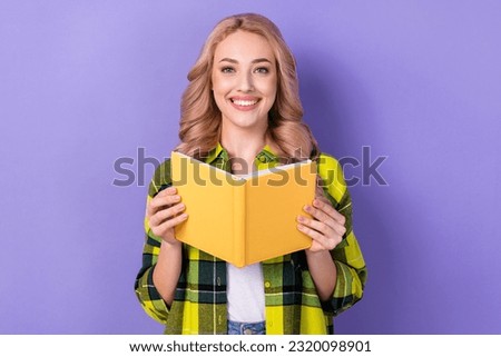 Photo of sweet cheerful lady wear plaid yellow shirt reading interesting book isolated violet color background