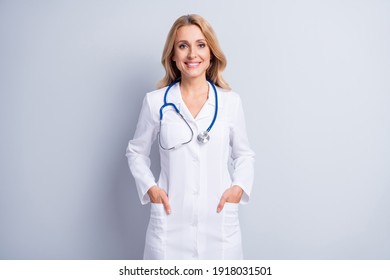 Photo of sweet confident age woman therapist dressed white coat arms pockets isolated grey color background