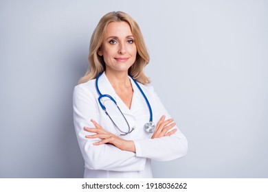 Photo Of Sweet Confident Mature Lady Doctor Wear White Coat Arms Crossed Empty Space Isolated Grey Color Background