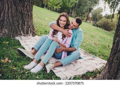 Photo Of Sweet Cute Boyfriend Girlfriend Wear Casual Outfits Sitting Grass Hugging Typing Device Enjoying Sunny Weather Outdoors Garden