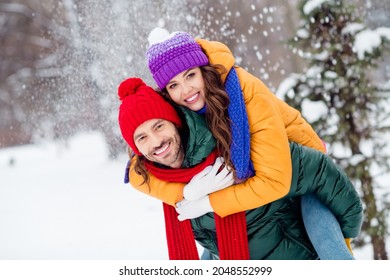 Photo of sweet cute marriage couple wear windbreakers hugging smiling having fun walking snowy weather outside park