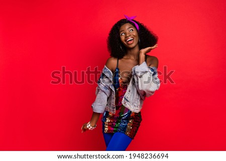 Photo of sweet cute wavy dark skin lady wear pin up outfit dancing looking empty space isolated red color background
