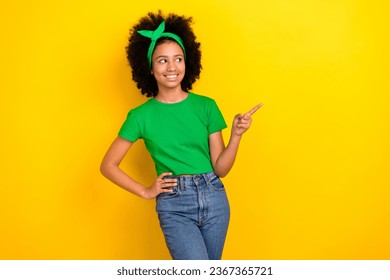 Photo of sweet dreamy girl dressed green t-shirt hairband looking showing finger empty space isolated yellow color background - Shutterstock ID 2367365721