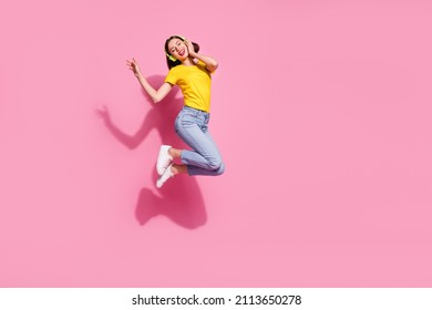 Photo Of Sweet Dreamy Young Woman Wear Yellow Outfit Jumping High Listening Songs Headphones Empty Space Isolated Pink Color Background