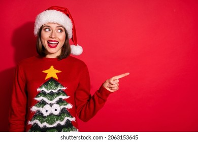 Photo of sweet excited young lady dressed print pullover enjoying christmas pointing finger empty space smiling isolated red color background - Powered by Shutterstock