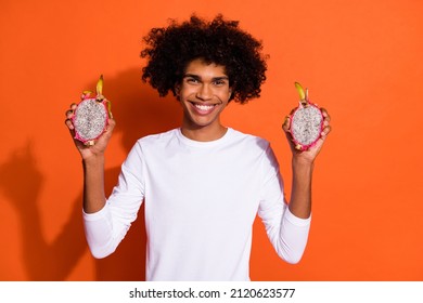 Photo Of Sweet Funny Guy Dressed White Shirt Smiling Holding Tropical Fruit Isolated Orange Color Background