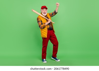 Photo Of Sweet Lucky Mature Man Dressed Yellow Waistcoat Smiling Playing Baseball Rising Fist Isolated Green Color Background