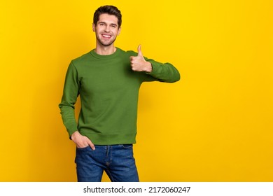 Photo of sweet pretty guy dressed green pullover showing thumb up empty space isolated yellow color background