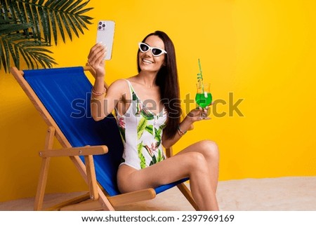 Photo of sweet pretty lady wear swimsuit relaxing lounge chair recording video vlogging gadget isolated yellow color background