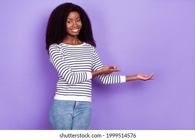 Photo of sweet young lady point hold empty space wear striped pullover isolated on violet color background