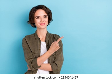 Photo Of Sweet Young Short Hairstyle Lady Show Promo Wear Trend Cloth Isolated On Blue Color Background