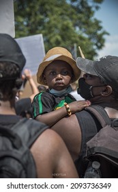 Photo take by Jon Espada in Hartford, Connecticut during a BLM protest of a toddler looking over his mother's shoulders. Taken on June 6, 2020
