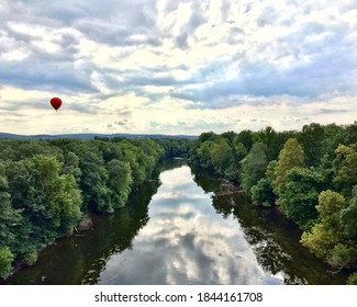 Photo Taken From A Hot Air Balloon Over Looking A River With Another Hot Air Ballon In The Distance