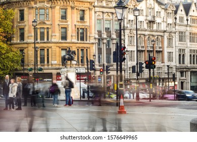 Photo taken on the 11th November 2019 at trafalgar square, London, United Kingdom. photo illustrates traffic lights, long exposed car lights, pedestrians, buildings, tube station, trees and fountains.
