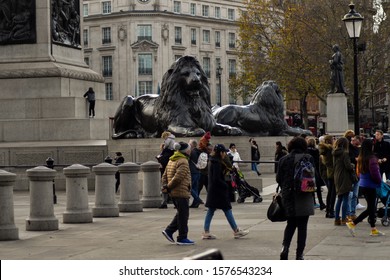 Photo taken on the 22nd November 2019 at trafalgar square London, United Kingdom. Photo illustrates the lion statues, charing cross underground entrance, victorian lamps, pedestrians and toruists.
