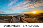 Photo taken in Punta Umbria, Huelva, Spain. It is a plank path that leads to the beach, in a magical sunset.