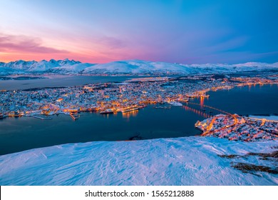 Photo was taken from Tromso,Norway. It was a winter snowy season and the snow make all the place looks different. Tromso sunsets are the most colorful sunsets I ever witnessed - Powered by Shutterstock