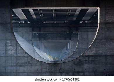 Photo Taken Under A Huge Bridge, Between Its Supports, Which Go Into Perspective