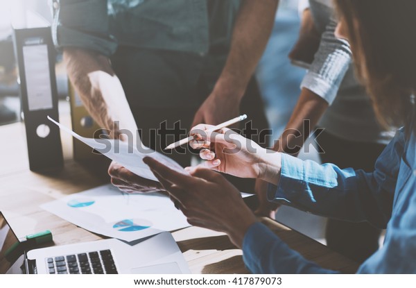 Photo team work process,holding contract
hand,signs documents. Account managers young crew works with
startup project.New idea presentation, analyze marketing reports.
Blurred, film effect,
horizontal