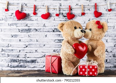 A Photo Of Teddy Bear Have A Gift To Girl Friend With White Brick Wall Background, Valentine Concept
