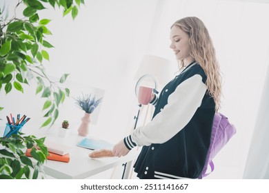 Photo of teen blonde sweet adorable lady eat breakfast drink tea dressed stylish uniform chill apartment bedroom white light interior - Powered by Shutterstock