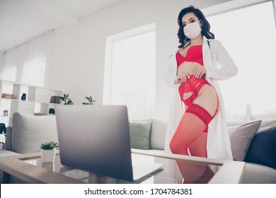 Photo Of Tempting Slim Hot Seductive Lady Work Home Online Chat Talk Rich Client Undressing Show Hot Body Play Seduce Nurse Role Take Off Lab Coat Look Notebook Wear Red Bikini Flu Mask Room Indoors