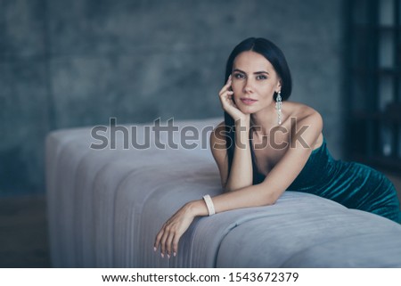 Photo of tenderness classy lady leaning on comfortable sofa waiting boyfriend home wear teasing classy formalwear short shiny dress apartments indoors