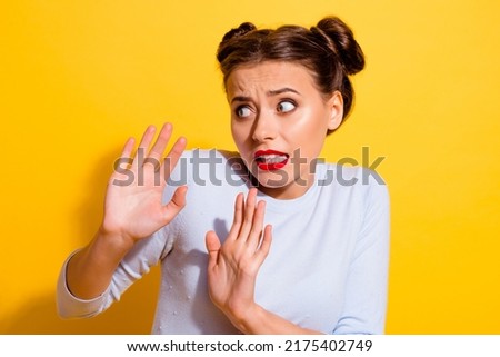 Photo of terrified young female try to avoid annoying person asking to stop isolated on yellow color background