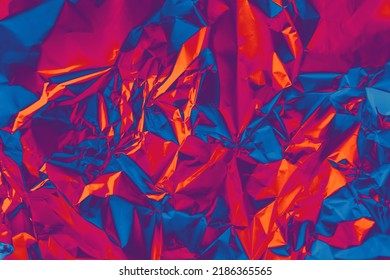 Photo Texture Of Glossy Metal Surface In Holographic Spectral Palette. Shiny Foil In Orange, Purple, Very Peri, Blue Color Background