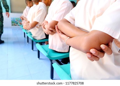 Photo Of Thai Students Are Arm Crossing Behind Before Eating Lunch In The Discipline Conduct At Paknampran School, Paknampran, Pranburi, Thailand December 3, 2018