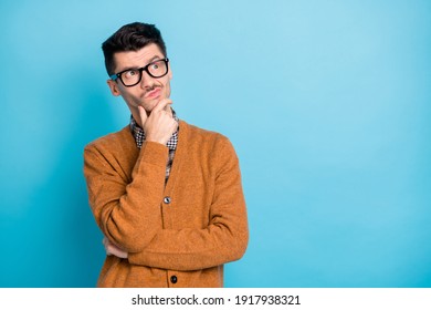 Photo Of Thoughtful Handsome Young Man Hold Hand Chin Think Look Empty Space Dream Isolated On Blue Color Background