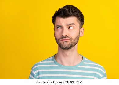 Photo Of Thoughtful Serious Man Stylish Haircut Dressed Striped T-shirt Look Empty Space Furrowed Brow Isolated On Yellow Color Background