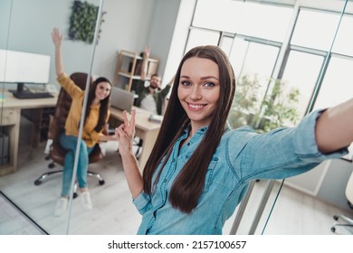 Photo of three corporate partners make selfie hand fingers demonstrate v-sign workstation indoors