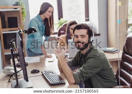 Photo of three employee operator sitting chair communicate speak clients office building indoors