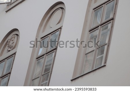 Photo of three retro windows from an old building in the center of Budapest