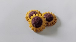 Photo Of Three Sunflower Biscuits With White Background 