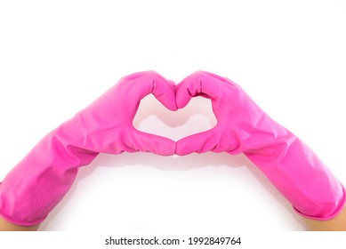 Photo top view of hands in pink gloves making heart with fingers on isolated blue background with copy space - Shutterstock ID 1992849764