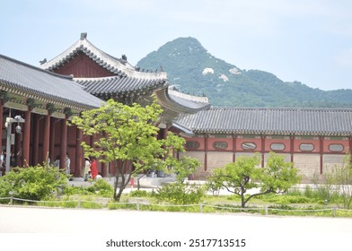 Photo of a traditional Korean palace hallway seen from the front yard with a rear view of a mountain - Powered by Shutterstock